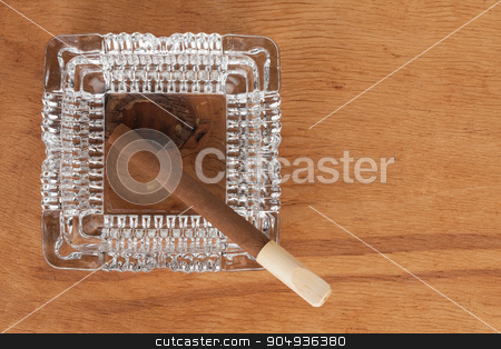 To use this stock image in your creative project, please select the size you need over to the right and click the "Add to Cart" button.
Your downloaded image will come with the Cutcaster watermark removed so don’t worry about the watermark you see on this page. Glass ashtray with cigar stands on a wooden surface stock photo, Glass ashtray with cigar stands on a wooden surface, can be used as background by alekleks