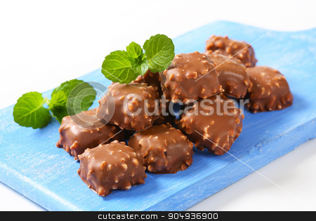 To use this stock image in your creative project, please select the size you need over to the right and click the "Add to Cart" button.
Your downloaded image will come with the Cutcaster watermark removed so don’t worry about the watermark you see on this page. Chocolate pralines stock photo, Chocolate pralines with chopped nuts by Digifoodstock
