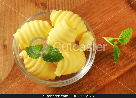 To use this stock image in your creative project, please select the size you need over to the right and click the "Add to Cart" button.
Your downloaded image will come with the Cutcaster watermark removed so don’t worry about the watermark you see on this page. Bowl of butter curls stock photo, Curls of fresh butter in glass bowl by Digifoodstock