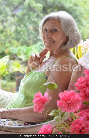 To use this stock image in your creative project, please select the size you need over to the right and click the "Add to Cart" button.
Your downloaded image will come with the Cutcaster watermark removed so don’t worry about the watermark you see on this page. Older woman with flowers stock photo, Portrait of a beautiful older woman with flowers by Ruslan Huzau