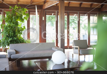 To use this stock image in your creative project, please select the size you need over to the right and click the "Add to Cart" button.
Your downloaded image will come with the Cutcaster watermark removed so don’t worry about the watermark you see on this page. Bright living room with big windows stock photo, Bright living room with a beige sofa, coffee table with sphere illuminator, some house plants and big windows by JRstock