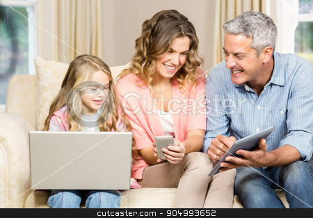 To use this stock image in your creative project, please select the size you need over to the right and click the "Add to Cart" button.
Your downloaded image will come with the Cutcaster watermark removed so don’t worry about the watermark you see on this page. Happy family using laptop, tablet and smartphone stock photo, Happy family using laptop, tablet and smartphone at home by Wavebreak Media