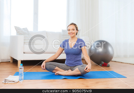 To use this stock image in your creative project, please select the size you need over to the right and click the "Add to Cart" button.
Your downloaded image will come with the Cutcaster watermark removed so don’t worry about the watermark you see on this page. woman making yoga in lotus pose on mat stock photo, fitness, sport, people and healthy lifestyle concept - woman making yoga in lotus pose on mat by Syda Productions
