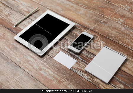 To use this stock image in your creative project, please select the size you need over to the right and click the "Add to Cart" button.
Your downloaded image will come with the Cutcaster watermark removed so don’t worry about the watermark you see on this page. close up of notebook, tablet pc and smartphone stock photo, business, education, objects and technology concept - close up of notebook, tablet pc computer and smartphone on table by Syda Productions