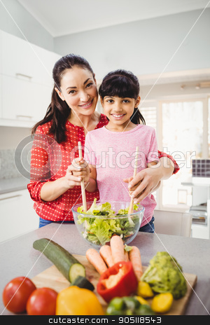 To use this stock image in your creative project, please select the size you need over to the right and click the "Add to Cart" button.
Your downloaded image will come with the Cutcaster watermark removed so don’t worry about the watermark you see on this page. Portrait of smiling mother and daughter preparing vegetable sala stock photo, Portrait of smiling mother and daughter preparing vegetable salad at home by Wavebreak Media