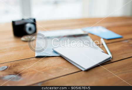 To use this stock image in your creative project, please select the size you need over to the right and click the "Add to Cart" button.
Your downloaded image will come with the Cutcaster watermark removed so don’t worry about the watermark you see on this page. close up of notepad with map and travel tickets stock photo, vacation, tourism, travel and objects concept - close up of blank notepad with map and airplane tickets by Syda Productions