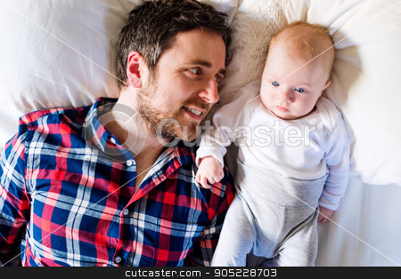 To use this stock image in your creative project, please select the size you need over to the right and click the "Add to Cart" button.
Your downloaded image will come with the Cutcaster watermark removed so don’t worry about the watermark you see on this page. Baby boy lying on bed, next to his father stock photo, Cute newborn baby boy lying on a bed, next to his father by HalfPoint
