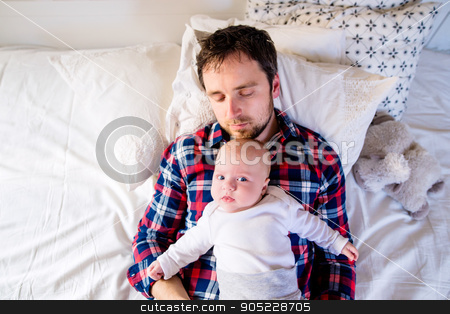 To use this stock image in your creative project, please select the size you need over to the right and click the "Add to Cart" button.
Your downloaded image will come with the Cutcaster watermark removed so don’t worry about the watermark you see on this page. Baby boy lying on bed with his father stock photo, Cute newborn baby boy lying on a bed with his father by HalfPoint