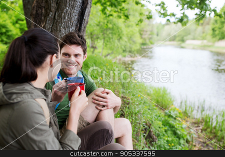 To use this stock image in your creative project, please select the size you need over to the right and click the "Add to Cart" button.
Your downloaded image will come with the Cutcaster watermark removed so don’t worry about the watermark you see on this page. happy couple with cups drinking in nature stock photo, travel, tourism, hike, camping and people concept - happy couple with cups drinking tea in nature on river bank by Syda Productions