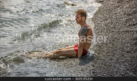 To use this stock image in your creative project, please select the size you need over to the right and click the "Add to Cart" button.
Your downloaded image will come with the Cutcaster watermark removed so don’t worry about the watermark you see on this page. Handsome muscular man on the beach laying on gravel stock photo, Handsome muscular shirtless man on the beach lying on gravel, looking at the sea by Stefano Cavoretto