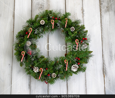 To use this stock image in your creative project, please select the size you need over to the right and click the "Add to Cart" button.
Your downloaded image will come with the Cutcaster watermark removed so don’t worry about the watermark you see on this page. Christmas wreath with decorations on rustic white wooden boards stock photo, Christmas wreath decorated with pine cones, candy canes, and red berries on rustic white wooden boards. by tab62
