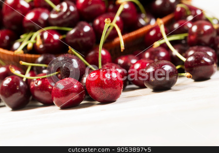 To use this stock image in your creative project, please select the size you need over to the right and click the "Add to Cart" button.
Your downloaded image will come with the Cutcaster watermark removed so don’t worry about the watermark you see on this page. Closeup of fresh ripe black cherries stock photo, Closeup horizontal view of black cherries, focus on front upright cherry, spilled out of basket onto white boards by tab62