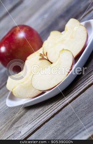 To use this stock image in your creative project, please select the size you need over to the right and click the "Add to Cart" button.
Your downloaded image will come with the Cutcaster watermark removed so don’t worry about the watermark you see on this page. Apple Slices stock photo, Angled vertical photo of fresh apple slices, on white plate, with whole apple and rustic wood in background by tab62