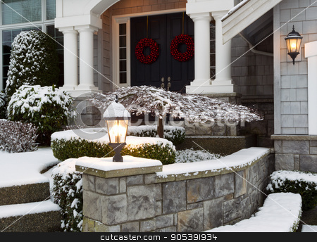 To use this stock image in your creative project, please select the size you need over to the right and click the "Add to Cart" button.
Your downloaded image will come with the Cutcaster watermark removed so don’t worry about the watermark you see on this page. Front of Home during the Winter Holidays stock photo, Closeup photo of home entrance during the holidays with fresh snow by tab62