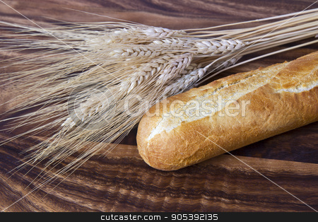 To use this stock image in your creative project, please select the size you need over to the right and click the "Add to Cart" button.
Your downloaded image will come with the Cutcaster watermark removed so don’t worry about the watermark you see on this page. Fresh Bread stock photo, Fresh bread with wheat stalk on black walnut board by tab62