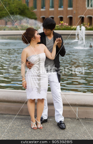To use this stock image in your creative project, please select the size you need over to the right and click the "Add to Cart" button.
Your downloaded image will come with the Cutcaster watermark removed so don’t worry about the watermark you see on this page. Young Adult Couple Holding Hands Near the Water Fountain stock photo, Vertical photo of young adult man holding his lady hand with water fountain, flowers, trees and brick building in background by tab62
