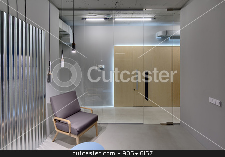 To use this stock image in your creative project, please select the size you need over to the right and click the "Add to Cart" button.
Your downloaded image will come with the Cutcaster watermark removed so don’t worry about the watermark you see on this page. Office in loft style stock photo, Business interior in a loft style with gray walls. There is a room with a glass partition with door, an armchair, a small table and a metal panel on the wall. Opposite the room there are wooden doors by bezikus