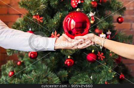 To use this stock image in your creative project, please select the size you need over to the right and click the "Add to Cart" button.
Your downloaded image will come with the Cutcaster watermark removed so don’t worry about the watermark you see on this page. Close up hands holding Christmas ball on x-mas tree background stock photo, Close up hands holding Christmas ball on x-mas tree background by Satura86