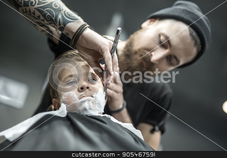 To use this stock image in your creative project, please select the size you need over to the right and click the "Add to Cart" button.
Your downloaded image will come with the Cutcaster watermark removed so don’t worry about the watermark you see on this page. Funny shaving of little boy stock photo, Little kid with a shaving foam on the face in the barbershop. He wears a black salon cape. Bearded barber with a tattoo is shaving boy's face with the help of the straight razor. Low aperture photo by bezikus
