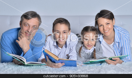 To use this stock image in your creative project, please select the size you need over to the right and click the "Add to Cart" button.
Your downloaded image will come with the Cutcaster watermark removed so don’t worry about the watermark you see on this page. family reading books stock photo, family reading books together on the floor by Ruslan Huzau