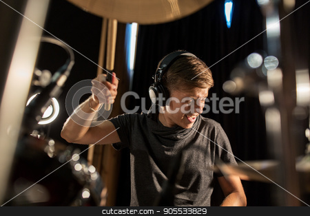 To use this stock image in your creative project, please select the size you need over to the right and click the "Add to Cart" button.
Your downloaded image will come with the Cutcaster watermark removed so don’t worry about the watermark you see on this page. male musician playing drums and cymbals at concert stock photo, music, people, musical instruments and entertainment concept - male musician in headphones with drumsticks playing drums and cymbals at concert or studio by Syda Productions