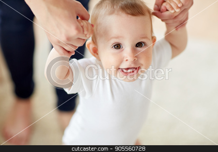 To use this stock image in your creative project, please select the size you need over to the right and click the "Add to Cart" button.
Your downloaded image will come with the Cutcaster watermark removed so don’t worry about the watermark you see on this page. happy baby learning to walk with mother help stock photo, family, child, childhood and parenthood concept - close up of happy little baby learning to walk with mother help at home by Syda Productions