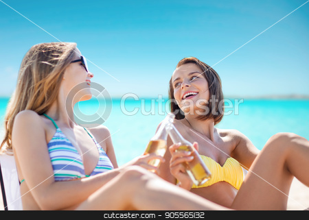To use this stock image in your creative project, please select the size you need over to the right and click the "Add to Cart" button.
Your downloaded image will come with the Cutcaster watermark removed so don’t worry about the watermark you see on this page. happy young women with drinks sunbathing on beach stock photo, summer holidays, vacation, travel and tourism people concept - smiling young women with drinks sunbathing on beach over sea and blue sky background by Syda Productions