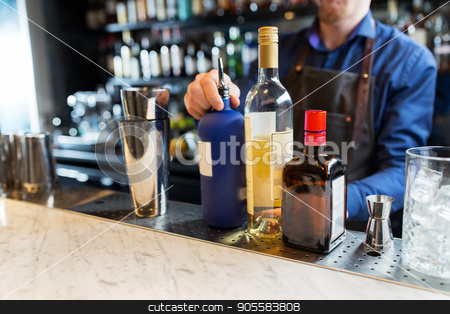 To use this stock image in your creative project, please select the size you need over to the right and click the "Add to Cart" button.
Your downloaded image will come with the Cutcaster watermark removed so don’t worry about the watermark you see on this page. barman with shaker, alcohol and jigger at bar stock photo, alcohol drinks, people and luxury concept - barman with shaker, bottles and jigger preparing cocktail at bar by Syda Productions