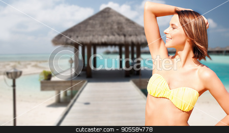 To use this stock image in your creative project, please select the size you need over to the right and click the "Add to Cart" button.
Your downloaded image will come with the Cutcaster watermark removed so don’t worry about the watermark you see on this page. happy woman in bikini swimsuit on tropical beach stock photo, people, summer holidays, vacation and travel concept - happy young woman posing in bikini swimsuit with raised hand over exotic tropical beach background by Syda Productions