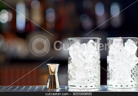 To use this stock image in your creative project, please select the size you need over to the right and click the "Add to Cart" button.
Your downloaded image will come with the Cutcaster watermark removed so don’t worry about the watermark you see on this page. glasses with ice and jigger on bar counter stock photo, alcohol drinks and luxury concept - two vintage glasses with ice cubes and jigger on bar counter by Syda Productions