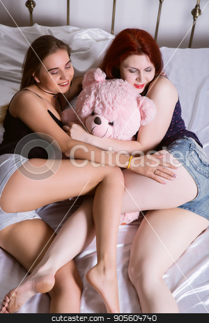 To use this stock image in your creative project, please select the size you need over to the right and click the "Add to Cart" button.
Your downloaded image will come with the Cutcaster watermark removed so don’t worry about the watermark you see on this page. Two girlfriends huging and kissing on a bed in bright bedroom. Lesbian couple with teddy bear stock photo, Two girlfriends huging and kissing on a bed in bright bedroom. Lesbian couple. by Alexander