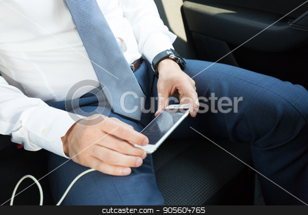 To use this stock image in your creative project, please select the size you need over to the right and click the "Add to Cart" button.
Your downloaded image will come with the Cutcaster watermark removed so don’t worry about the watermark you see on this page. Close up of businessman using mobile smart phone in a car. stock photo, Close up of a businessman using smart phone while driving on the back seat of a car. Focus on mobile device. by kasto