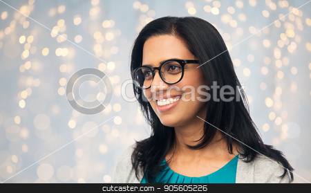 To use this stock image in your creative project, please select the size you need over to the right and click the "Add to Cart" button.
Your downloaded image will come with the Cutcaster watermark removed so don’t worry about the watermark you see on this page. happy smiling young indian woman in glasses stock photo, vision, portrait and people concept - happy smiling young indian woman in glasses over holidays lights background by Syda Productions