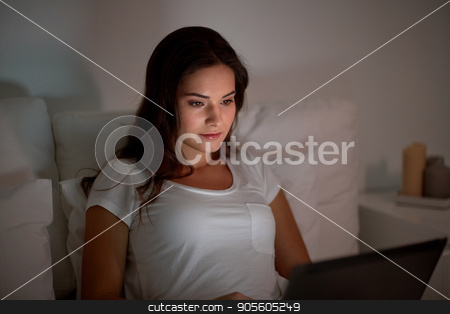 To use this stock image in your creative project, please select the size you need over to the right and click the "Add to Cart" button.
Your downloaded image will come with the Cutcaster watermark removed so don’t worry about the watermark you see on this page. young woman with laptop in bed at home bedroom stock photo, technology, internet, communication and people concept - young woman with laptop computer in bed at home bedroom at night by Syda Productions