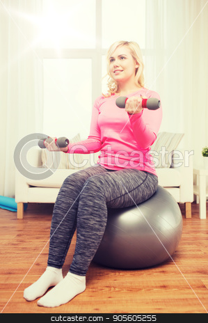 To use this stock image in your creative project, please select the size you need over to the right and click the "Add to Cart" button.
Your downloaded image will come with the Cutcaster watermark removed so don’t worry about the watermark you see on this page. smiling woman with dumbbells exercising at home stock photo, fitness, sport, training and lifestyle concept - smiling woman with dumbbells and fit ball exercising at home by Syda Productions