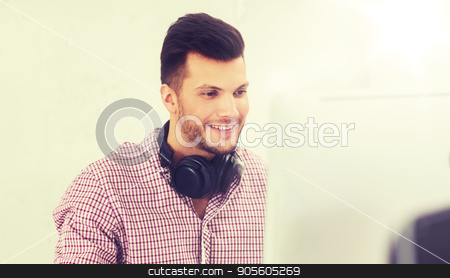 To use this stock image in your creative project, please select the size you need over to the right and click the "Add to Cart" button.
Your downloaded image will come with the Cutcaster watermark removed so don’t worry about the watermark you see on this page. creative man with headphones and computer stock photo, business, startup, education, technology and people concept - happy creative man or student with headphones and computer at office by Syda Productions
