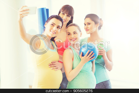 To use this stock image in your creative project, please select the size you need over to the right and click the "Add to Cart" button.
Your downloaded image will come with the Cutcaster watermark removed so don’t worry about the watermark you see on this page. pregnant women taking selfie by smartphone in gym stock photo, pregnancy, sport, fitness, people and healthy lifestyle concept - group of happy pregnant women with sports stuff taking selfie by smartphone in gym by Syda Productions