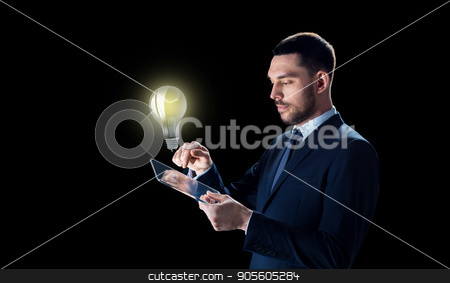 To use this stock image in your creative project, please select the size you need over to the right and click the "Add to Cart" button.
Your downloaded image will come with the Cutcaster watermark removed so don’t worry about the watermark you see on this page. businessman with tablet pc and lightbulb stock photo, business, people, startup idea, inspiration and modern technology concept - businessman in suit working with transparent tablet pc computer and lightbulb over black background by Syda Productions