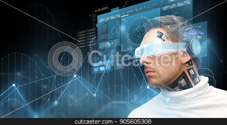 To use this stock image in your creative project, please select the size you need over to the right and click the "Add to Cart" button.
Your downloaded image will come with the Cutcaster watermark removed so don’t worry about the watermark you see on this page. man in virtual reality glasses and microchip stock photo, augmented reality, technology, business, future and people concept - man in virtual glasses and microchip implant or sensors looking at screen projections with diagram charts over dark background by Syda Productions