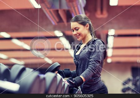 To use this stock image in your creative project, please select the size you need over to the right and click the "Add to Cart" button.
Your downloaded image will come with the Cutcaster watermark removed so don’t worry about the watermark you see on this page. young smiling woman choosing dumbbells in gym stock photo, fitness, sport, exercising, weightlifting and people concept - young smiling woman choosing dumbbells in gym by Syda Productions