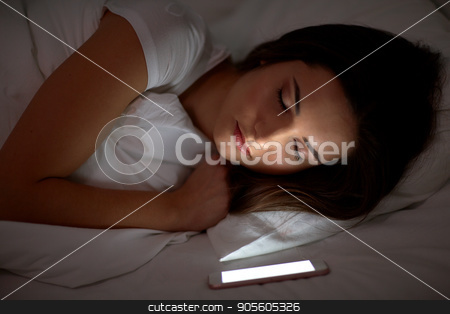 To use this stock image in your creative project, please select the size you need over to the right and click the "Add to Cart" button.
Your downloaded image will come with the Cutcaster watermark removed so don’t worry about the watermark you see on this page. woman with smartphone sleeping in bed at night stock photo, technology and people concept - young woman with smartphone sleeping in bed at home at night by Syda Productions