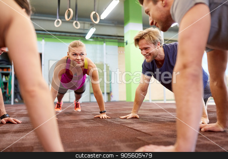 To use this stock image in your creative project, please select the size you need over to the right and click the "Add to Cart" button.
Your downloaded image will come with the Cutcaster watermark removed so don’t worry about the watermark you see on this page. group of people doing straight arm plank in gym stock photo, fitness, sport, exercising, training and healthy lifestyle concept - group of people doing straight arm plank in gym by Syda Productions