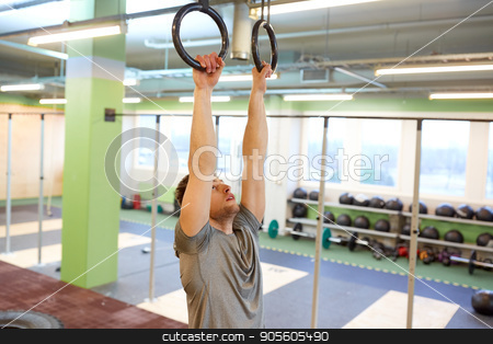 To use this stock image in your creative project, please select the size you need over to the right and click the "Add to Cart" button.
Your downloaded image will come with the Cutcaster watermark removed so don’t worry about the watermark you see on this page. man exercising and doing ring pull-ups in gym stock photo, sport, fitness, training and people concept - man exercising and doing ring pull-ups in gym by Syda Productions