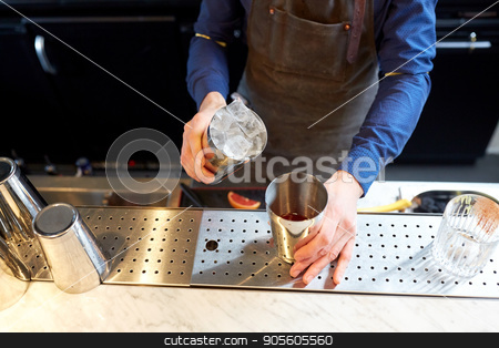 To use this stock image in your creative project, please select the size you need over to the right and click the "Add to Cart" button.
Your downloaded image will come with the Cutcaster watermark removed so don’t worry about the watermark you see on this page. bartender with ice and shaker at cocktail bar stock photo, alcohol drinks, people and luxury concept - bartender adding ice into shaker preparing cocktail at bar by Syda Productions