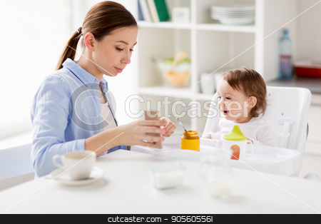 To use this stock image in your creative project, please select the size you need over to the right and click the "Add to Cart" button.
Your downloaded image will come with the Cutcaster watermark removed so don’t worry about the watermark you see on this page. mother with smartphone and baby eating at home stock photo, family, breakfast, eating, technology and people concept - happy mother with smartphone and coffee and little baby sitting in highchair at home kitchen by Syda Productions