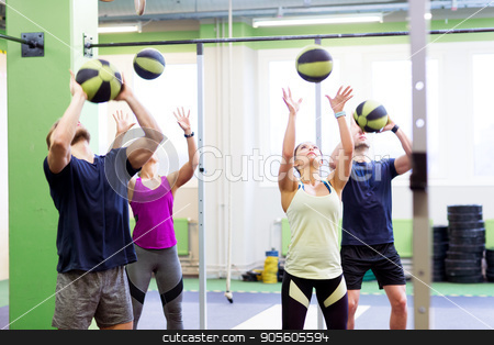 To use this stock image in your creative project, please select the size you need over to the right and click the "Add to Cart" button.
Your downloaded image will come with the Cutcaster watermark removed so don’t worry about the watermark you see on this page. group of people with medicine ball training in gym stock photo, fitness, sport and exercising concept - group of people with medicine balls training in gym by Syda Productions