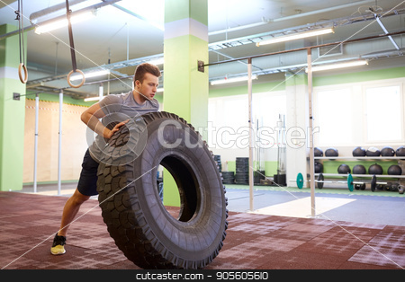 To use this stock image in your creative project, please select the size you need over to the right and click the "Add to Cart" button.
Your downloaded image will come with the Cutcaster watermark removed so don’t worry about the watermark you see on this page. man doing strongman tire flip training in gym stock photo, strongman, bodybuilding, sport, fitness and people concept - young man doing tire flip at training in gym by Syda Productions