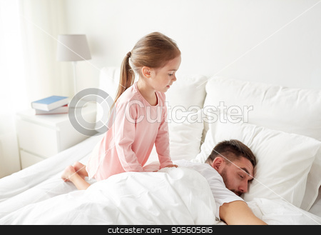 To use this stock image in your creative project, please select the size you need over to the right and click the "Add to Cart" button.
Your downloaded image will come with the Cutcaster watermark removed so don’t worry about the watermark you see on this page. little girl waking her sleeping father up in bed stock photo, people, family and morning concept - happy little girl waking her sleeping father up in bed at home by Syda Productions
