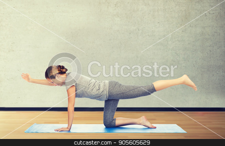 To use this stock image in your creative project, please select the size you need over to the right and click the "Add to Cart" button.
Your downloaded image will come with the Cutcaster watermark removed so don’t worry about the watermark you see on this page. woman making yoga in balancing table pose on mat stock photo, fitness, sport, people and healthy lifestyle concept - woman making yoga in balancing table pose on mat over gym room background by Syda Productions