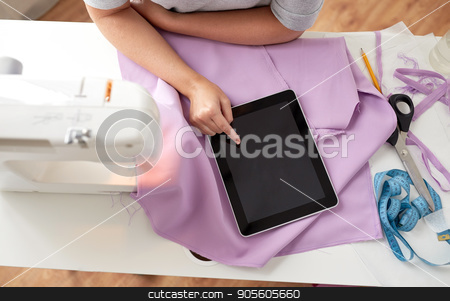 To use this stock image in your creative project, please select the size you need over to the right and click the "Add to Cart" button.
Your downloaded image will come with the Cutcaster watermark removed so don’t worry about the watermark you see on this page. tailor with sewing machine, tablet pc and fabric stock photo, people, needlework, technology and tailoring concept - tailor woman with sewing machine, tablet pc and fabric by Syda Productions
